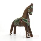 A dun horse with a flower harness