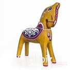 A yellow-orange horse with a purple blanket